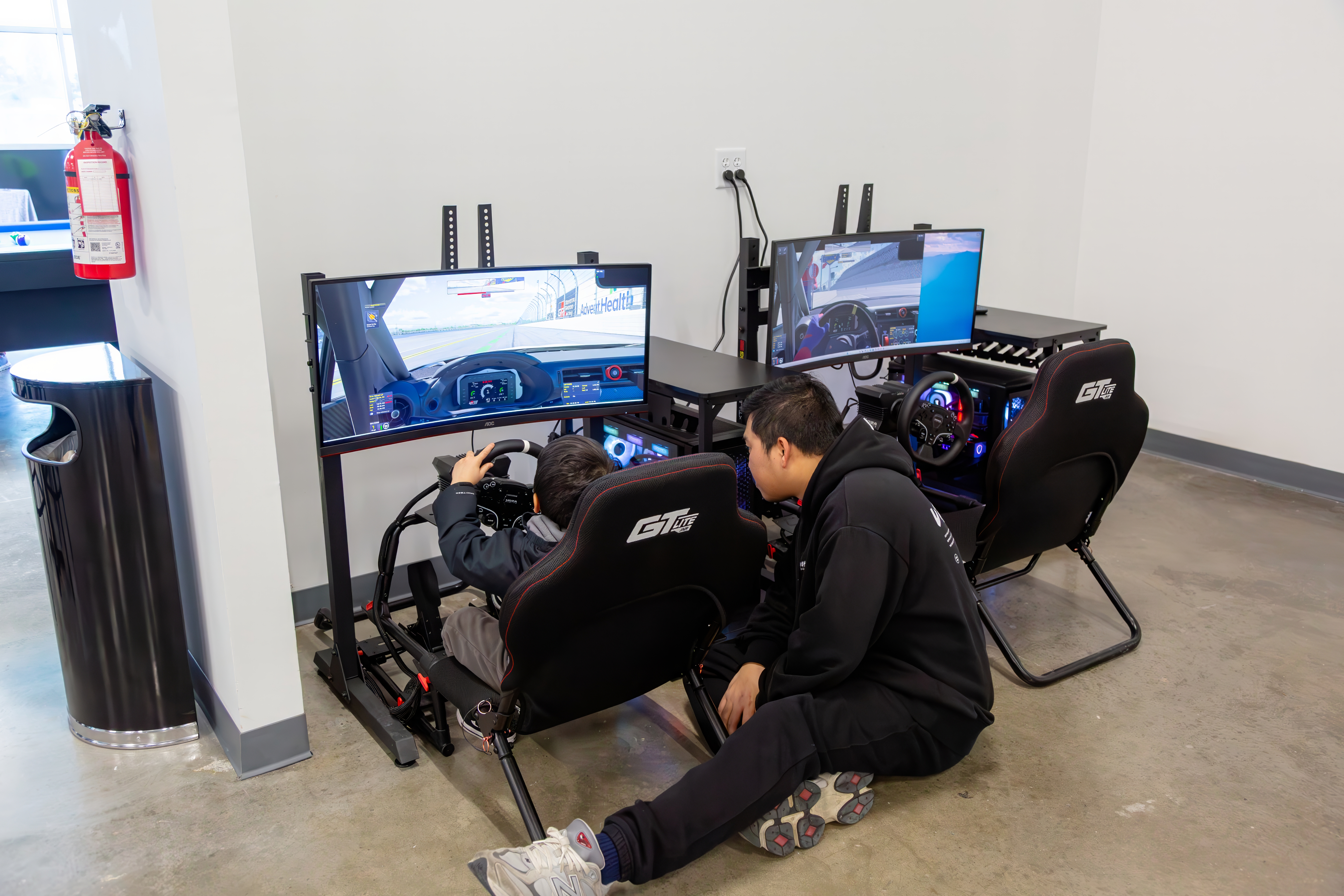 Kid rig — staff coaching a younger driver, junior seat