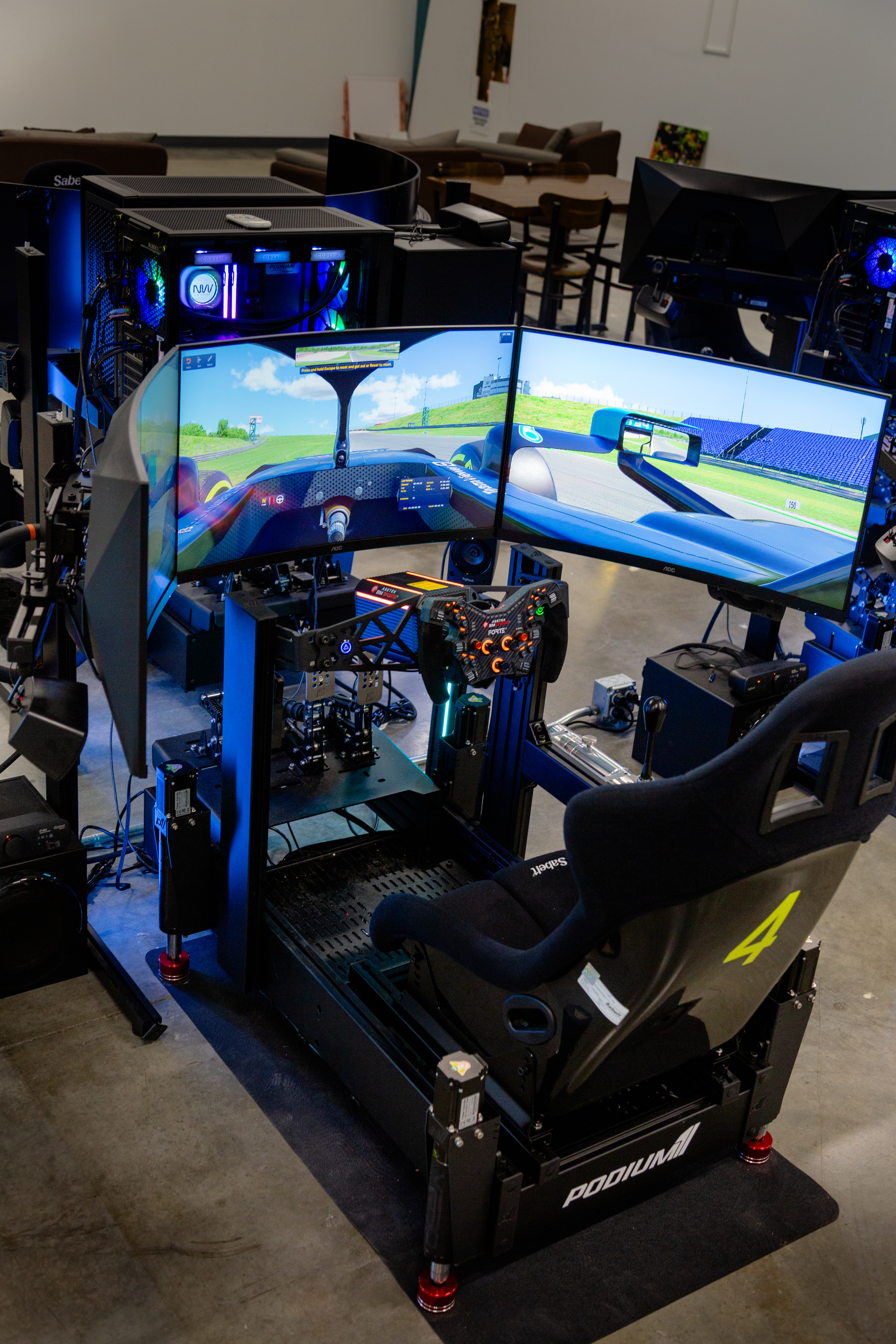 Pro cockpit — Sabelt racing seat, triple monitors, Asetek Forte wheel
